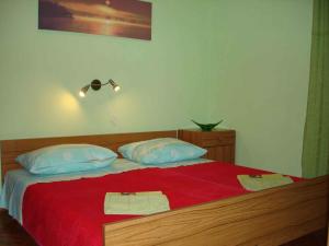 a bedroom with a bed with two towels on it at Holiday home in Slatine/Insel Ciovo 6128 in Slatine