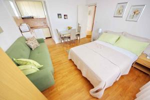 Apartment Vrsi -Mulo 2 في Kod Mula: غرفة نوم بسرير واريكة وطاولة