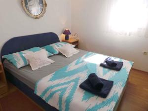 a bedroom with a bed with towels on it at Apartment Trogir 6 in Okrug Donji