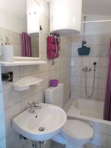 a bathroom with a sink and a toilet and a shower at Apartment Trogir 6 in Okrug Donji
