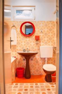 a bathroom with a sink and a toilet and a mirror at Apartment in Pucisca/Insel Brac 5972 in Pučišća