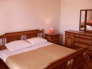 a bedroom with a bed with a dresser and a mirror at Holiday home Zaglav/Insel Dugi Otok 6296 in Zaglav