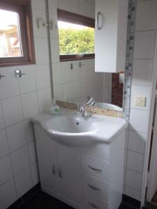 a bathroom with a sink and a mirror at Holiday Home Gohren - Ostseebad 1 in Göhren