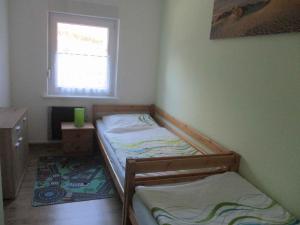 a small room with two beds and a window at Holiday Home Gohren - Ostseebad 1 in Göhren