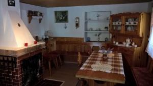 Holiday home in Pernink/Erzgebirge 1672 في Pernink: غرفة طعام مع طاولة ومدفأة