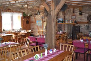 a restaurant with tables and chairs and a tree at Apartment in Fuhlendorf 2747 in Fuhlendorf
