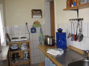 a kitchen with a sink and a counter with utensils at Holiday home Groß Kordshagen/Ostsee 2741 in Arbshagen