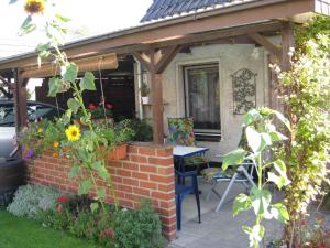 a patio with a wooden pergola and a table and chairs at Holiday home Groß Kordshagen/Ostsee 2741 in Arbshagen