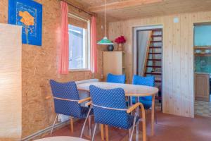 a dining room with a table and blue chairs at Apartment Svoboda nad upou 1 in Svoboda nad Úpou