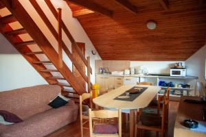 a living room with a table and a kitchen at Apartment Harrachov 3 in Harrachov