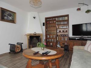 a living room with a coffee table and a tv at Holiday home Sedlonov/Adlergebirge 949 in Sedloňov