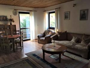 a living room with a couch and a table at Apartment Harrachov 10 in Harrachov