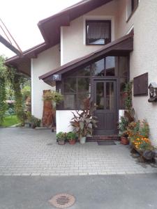 a front door of a house with potted plants at Apartment in Rokytnice nad Jizerou 2102 in Rokytnice nad Jizerou