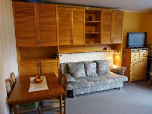 a living room with a couch and a table at Studio in Bad Aussee/Steiermark 428 in Helmbichl