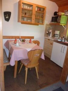 シュトローブルにあるApartment Strobl 1のキッチン(ピンクのテーブルクロス付きのテーブル付)