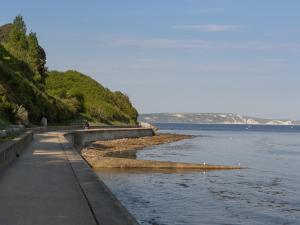 a sidewalk next to a body of water at Rockpools in Weymouth