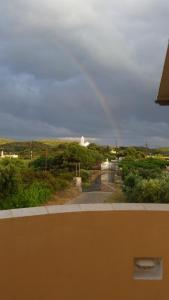 a view of a road with a rainbow in the sky at Emmanouil in Kythira