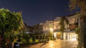 ein Gebäude mit vielen Pflanzen davor in der Unterkunft De Manora Homes - Unpretentious hotel with a garden , posh area Ranjit Avenue in Amritsar