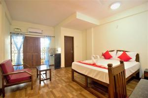 a bedroom with a bed and a chair at Casa Joseph in Candolim