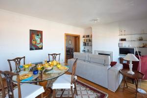 a living room with a table and a couch at Lighthouse View in Cascais in Cascais