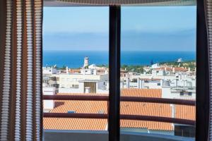 a view of a city skyline from a window at Lighthouse View in Cascais in Cascais