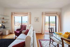 a living room with a couch and a table at Lighthouse View in Cascais in Cascais