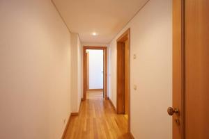an empty hallway with a door leading into a room at Lighthouse View in Cascais in Cascais