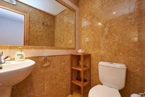 a bathroom with a sink and a toilet and a mirror at Lighthouse View in Cascais in Cascais
