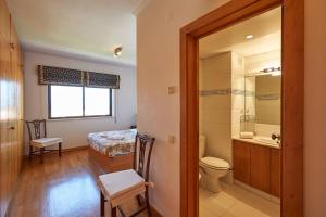 a bathroom with a bed and a sink and a toilet at Lighthouse View in Cascais in Cascais