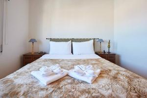 a bedroom with a bed with two towels on it at Lighthouse View in Cascais in Cascais