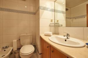 a bathroom with a white toilet and a sink at Lighthouse View in Cascais in Cascais