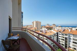 a balcony with a table and a view of a city at Lighthouse View in Cascais in Cascais