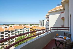 a balcony with a table and chairs on a building at Lighthouse View in Cascais in Cascais