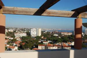 a view of a city from a balcony at Lighthouse View in Cascais in Cascais