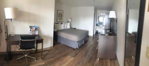 a hotel room with a bed and a desk and a desk at Sugarloaf Mountain Motel in Bend