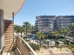 a balcony with a view of a marina and a building at ZEN MARINA in Mandelieu-La Napoule