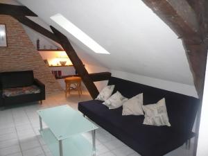 a living room with a couch and a table at gite la chapelle in Nailhac
