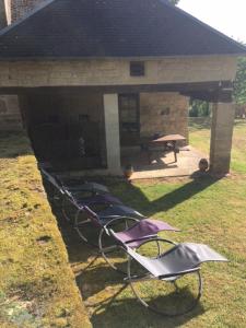 a group of chairs in front of a building at gite la chapelle in Nailhac