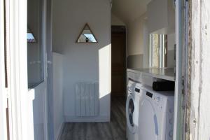 a laundry room with a washer and dryer at CALODURUM in Chilleurs-aux-Bois