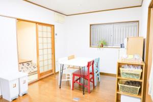 a kitchen with a table and chairs in a room at HAT Koizumi, near from JR Koizumi station 大和小泉駅徒歩2分の貸切一軒家 in Koizumi