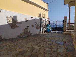 a building with a stone floor and a wall at Symi . VILLA CALME (Sur la Mer). in Symi