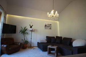 a living room with a couch and a chandelier at Alpenapartment Abtenau 2 - 6 Personen in Abtenau