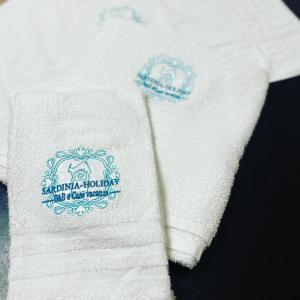 a close up of a white shirt with a blue logo at Sardinia-Holiday La casa delle Pavoncelle in La Maddalena +18 photos