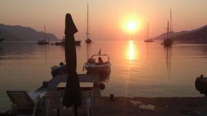 a sunset over a body of water with boats at Symi . VILLA CALME (Sur la Mer). in Symi