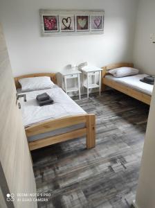 a room with two beds and two tables in it at Seepark Goch-Kessel in Kessel