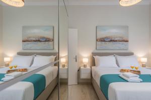 A bed or beds in a room at Old Harbor Apartment Luxury Living Chania