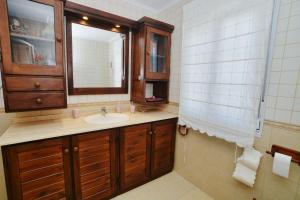 a bathroom with a sink and a mirror at Apartamento Ama - 5828 in Isla +16 photos