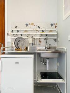 a kitchen with a sink and a counter top at Theros Lux Apts. in Plános