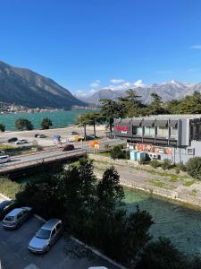 a highway with cars parked in a parking lot next to a river at Downtown Apartment in Kotor