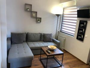 a living room with a couch and a table at Lemon Tree Inn in Markopoulo